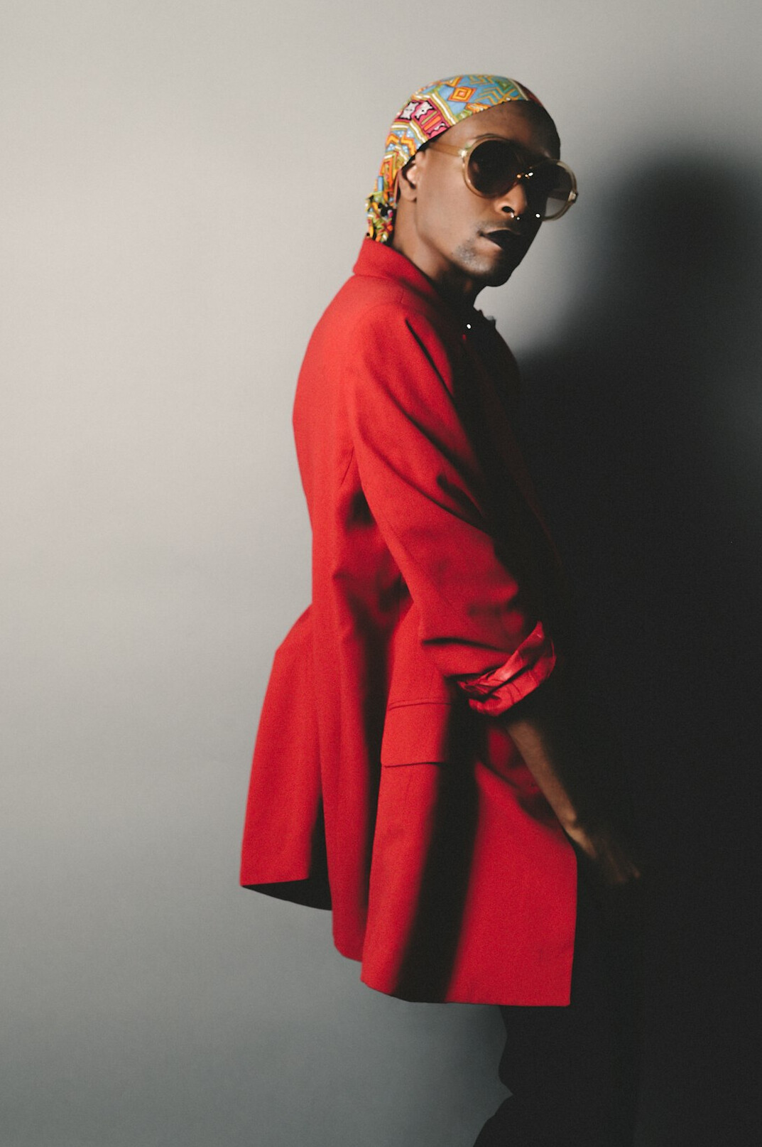Studio portrait of a Black woman in her forties with short natural hair wearing a blazer